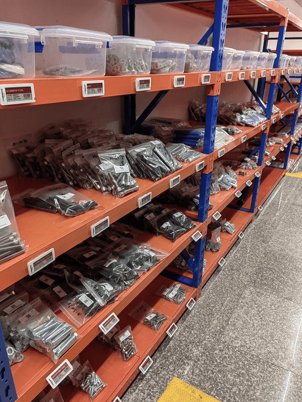 Electronic labels on warehouse storage bins for hardware inventory